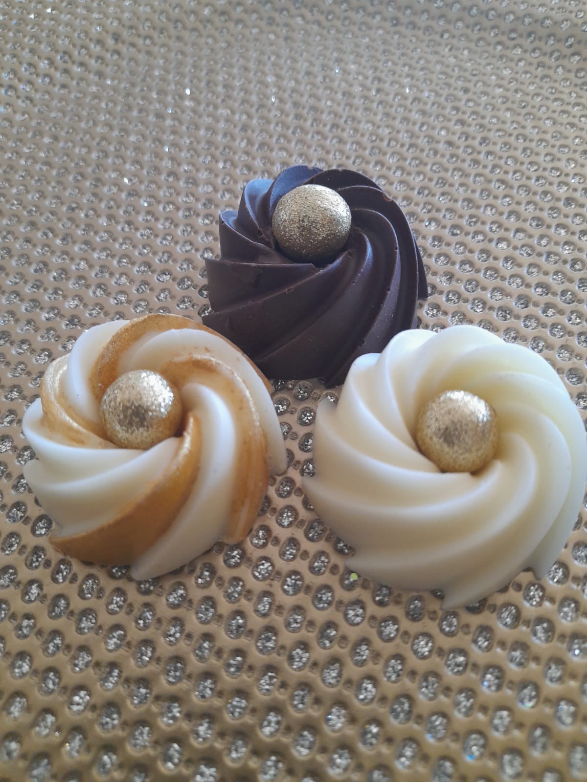 trio of chocolate twirls that include a dark chocolate twirl, white chocolate twirl and a white chocolate twirl with gold accents