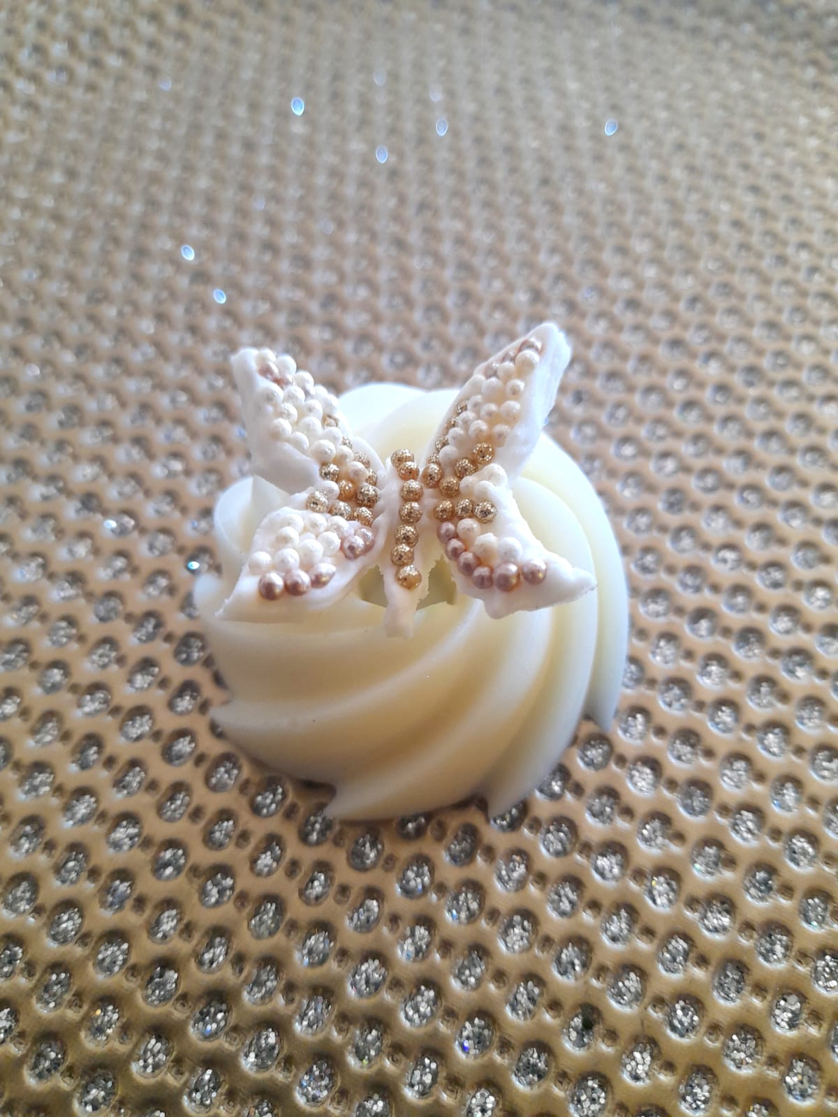 white chocolate twirl with a butterfly fondant on top