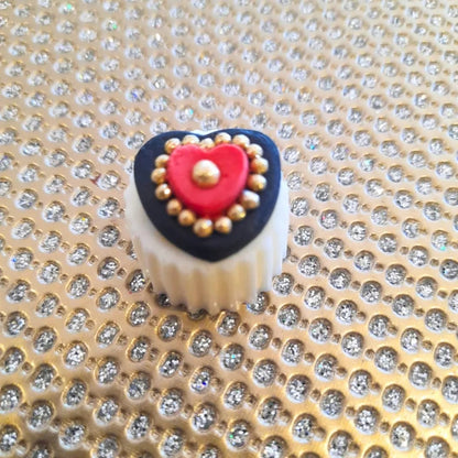 white chocolate hearts with a black and red fondant heart with edible gold nuggets